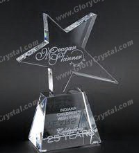 engraved crystal star trophy on a ladder-shaped base